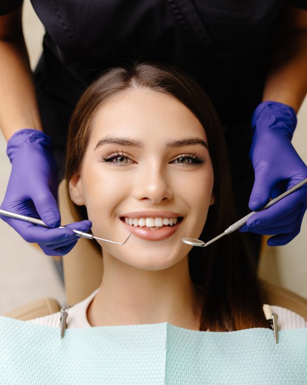 Dentist examining patient's teeth