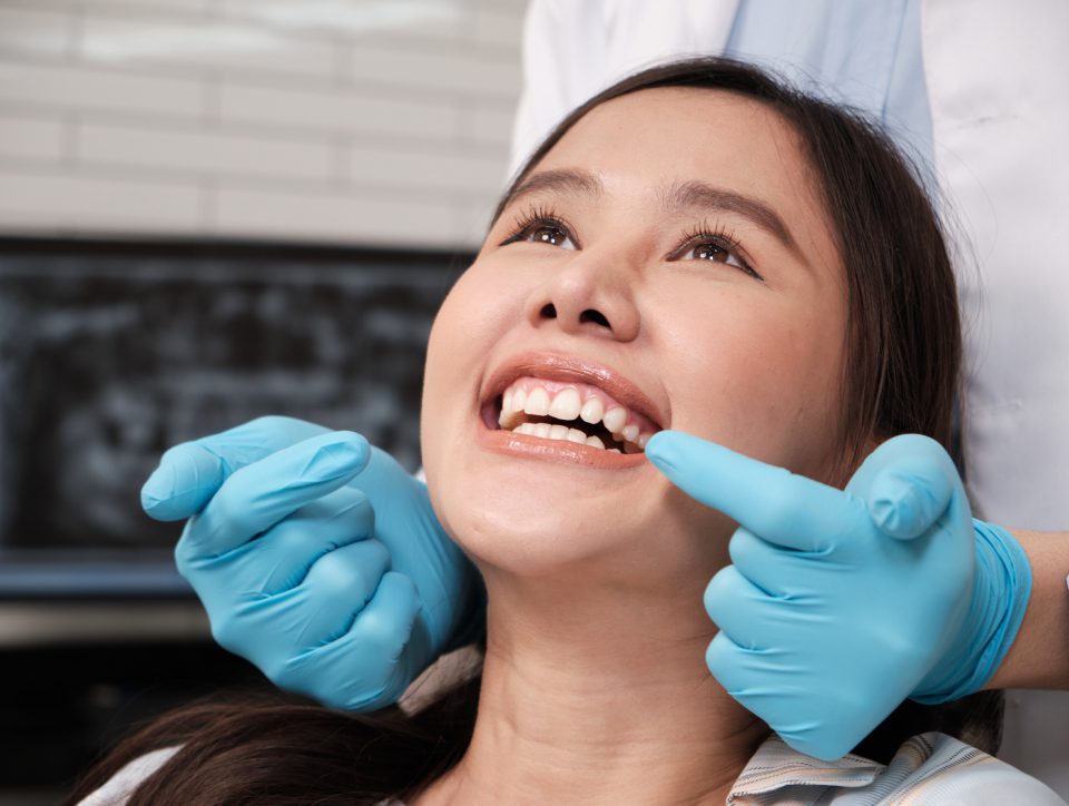 Dentist examining patient's teeth